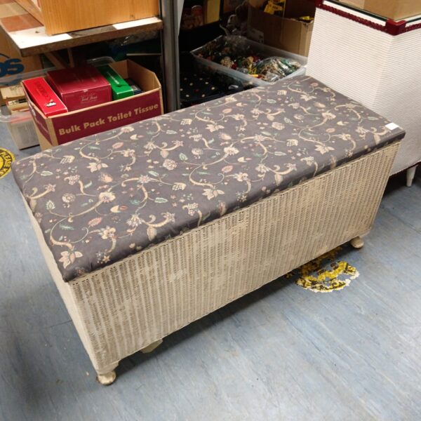 Vintage Lloyd Loom ottoman with patterned upholstery, a charming footstool.
