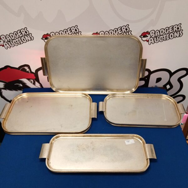 Set of four vintage Woodmet serving trays with metal handles.