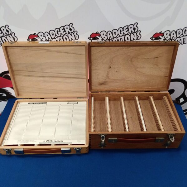 Vintage 35mm slide boxes open, showing individual slide slots for film storage.