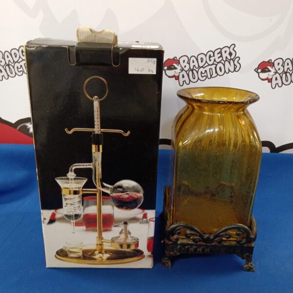 Vintage Falcool micro distiller on cast iron base, antique spirit distillation.