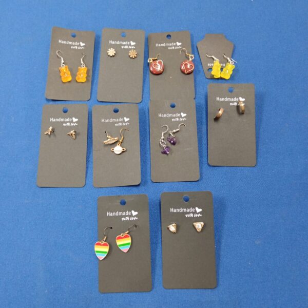 Close-up of a lot of colourful handmade dangle earrings.