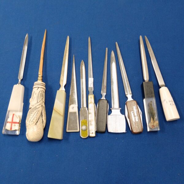 Group of vintage letter openers, collectible desk accessories.