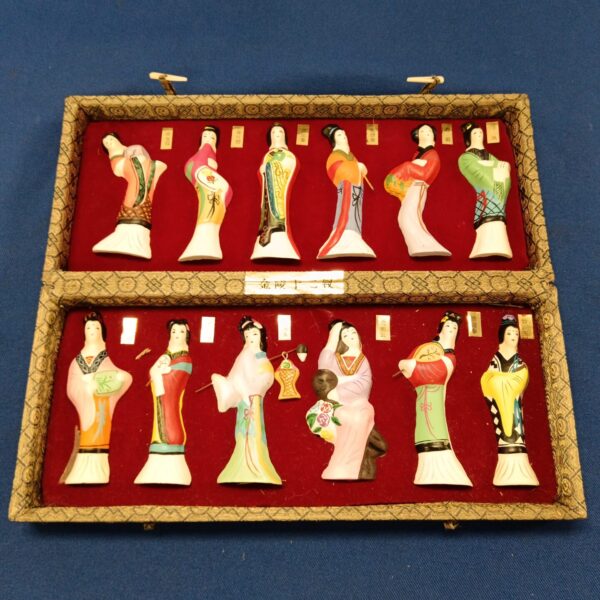 Vintage Chinese figurine set in a red presentation case.