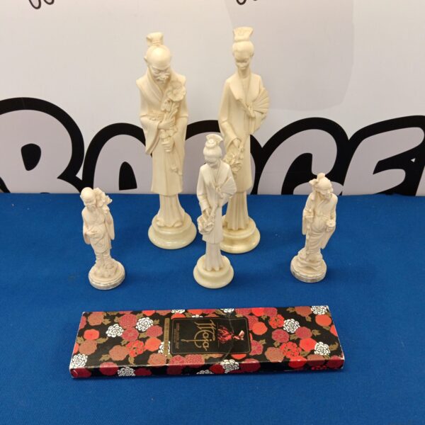 Vintage set of five Chinese Priest figures on display.