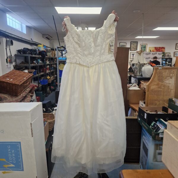 Elegant size 14 lace wedding dress with flowing skirt.