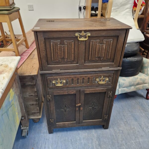 Front view of a vintage oak cocktail cabinet.