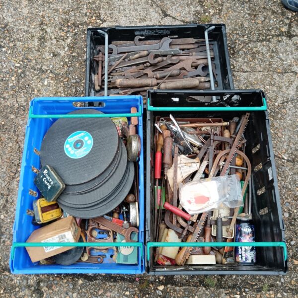 Overview of a vintage tool lot with various hand tools and cutting disks.