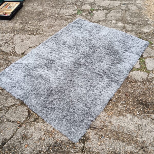 Soft shaggy grey rug measuring 120x170cm for living room comfort.