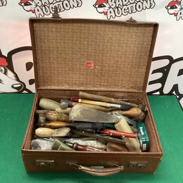 Vintage leather tool case filled with antique tools.