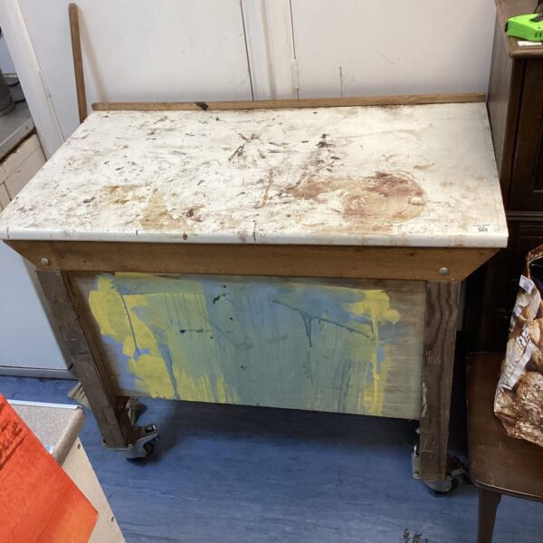 Vintage wheeled workbench with lifting top and storage.