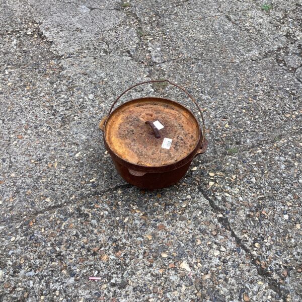 Vintage cast iron cooking pot with bail handle.
