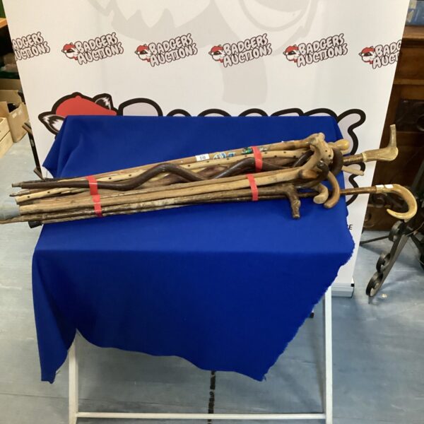 Bundle of fifteen wooden walking sticks for hiking and collecting.