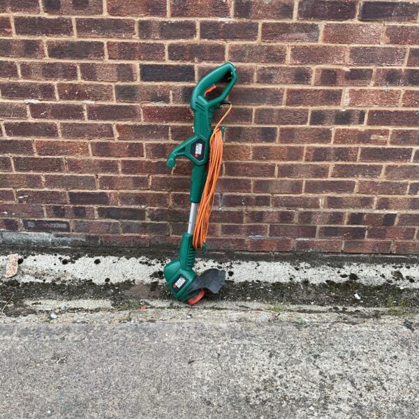 Black and Decker electric trimmer for garden maintenance and edging.