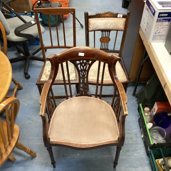 Antique armchair with upholstered seat and carved wooden frame.