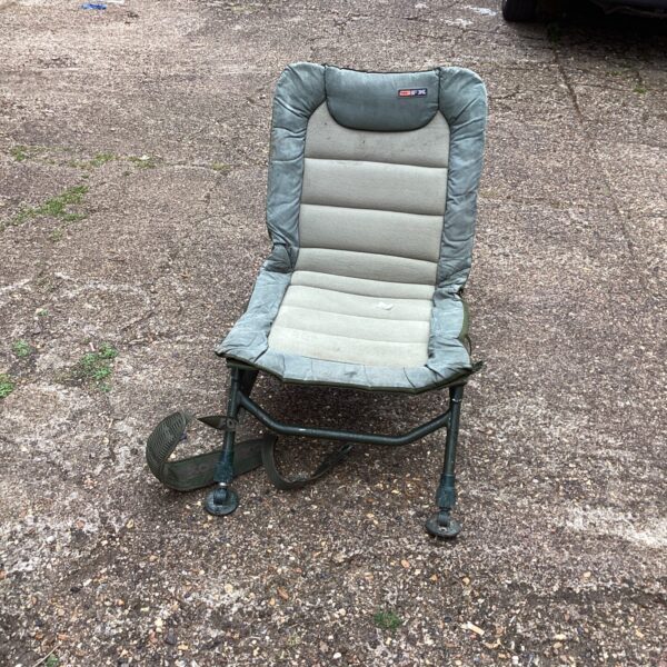 Side view of a used folding fishing chair.