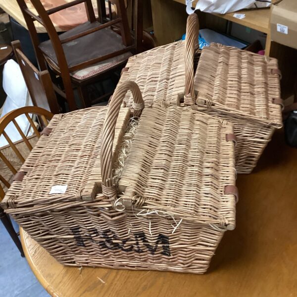 Vintage wicker picnic basket with a woven handle.