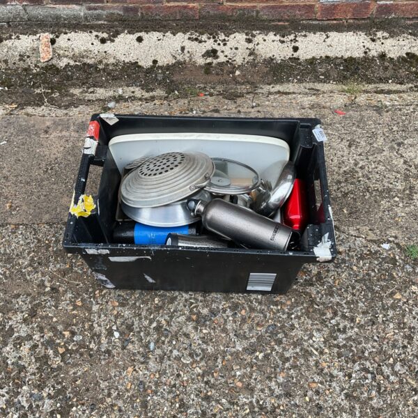 A box of vintage camping flasks and kitchen appliances.