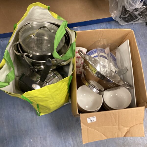 Stainless steel kitchen pots and pans set with bowls and plates.
