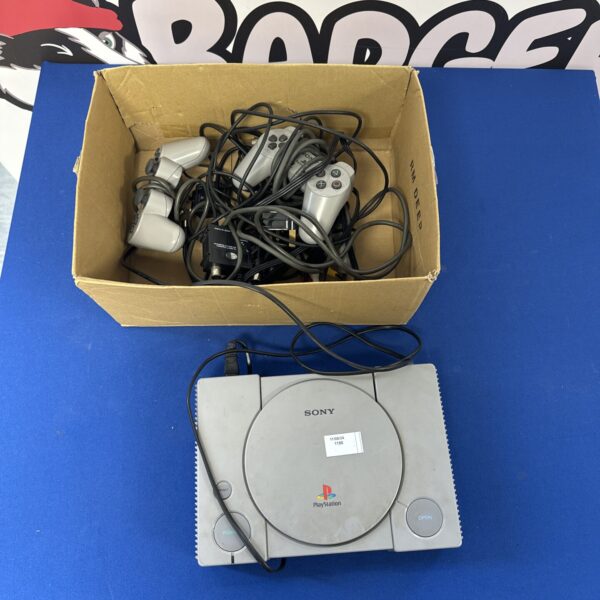 Vintage Sony Playstation 1 console with controllers and cables.
