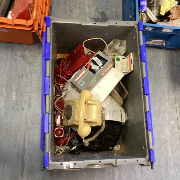 Crate of vintage corded telephones for collectors and retro enthusiasts.