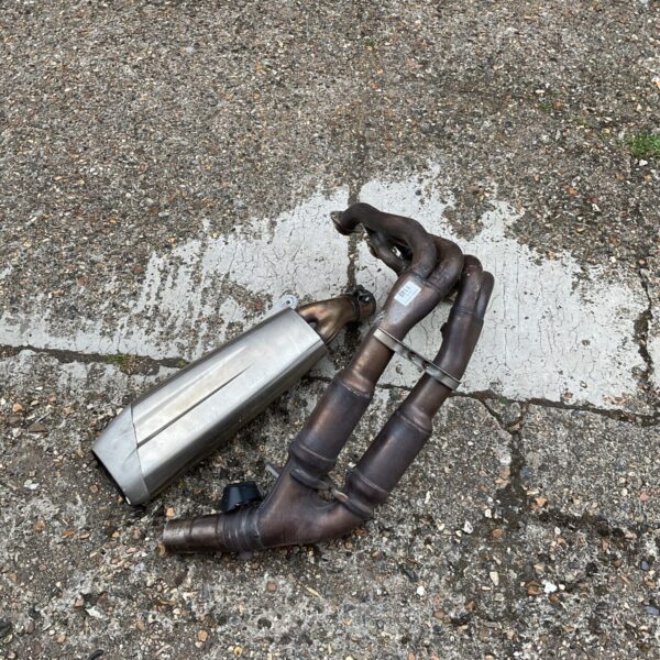 Used car exhaust manifold and connecting pipe for automotive repair.