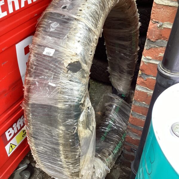 Rolled garden hose showing wear and tear.