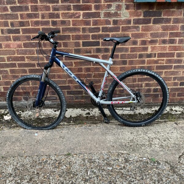 Grey and white GT Aggressor XC3 mountain bike for off-road cycling.