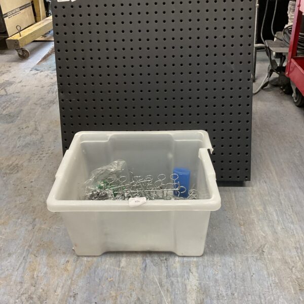 Perforated metal tool rack with included tool hooks for organization.