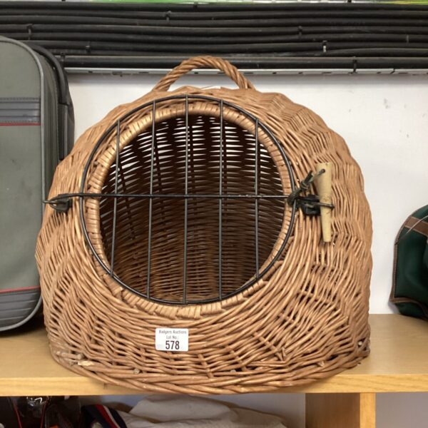 Vintage wicker pet carrier for small animals, classic design.