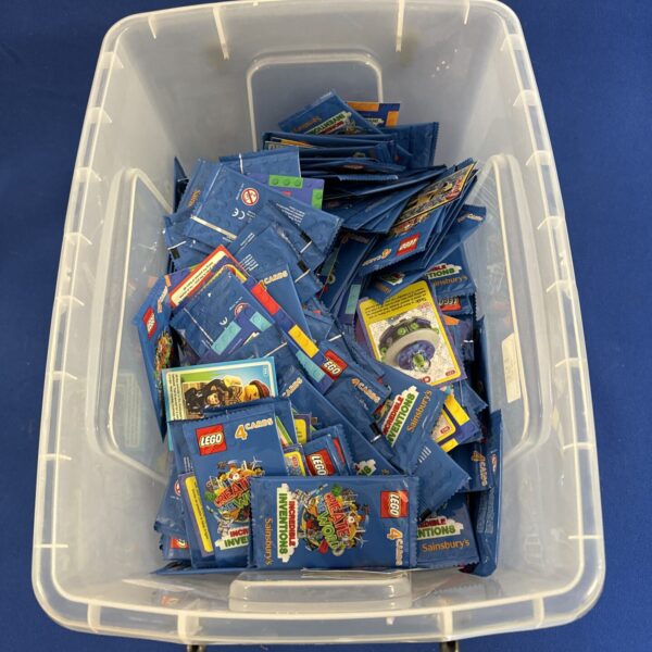 Unopened Lego Incredible Inventions card packs in a clear box.