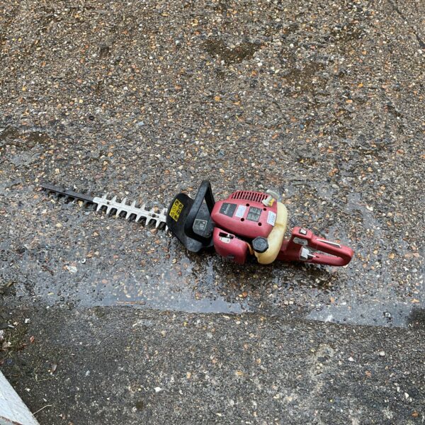 Front view of a used Sovereign hedge trimmer with long blades.
