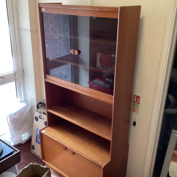 Vintage Arthur Newbury display cabinet with glazed door and shelving.
