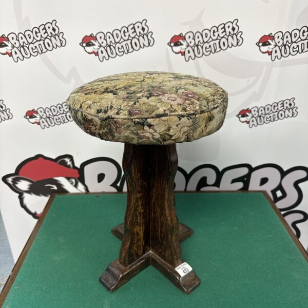 Vintage floral stool with colourful upholstery and turned legs.