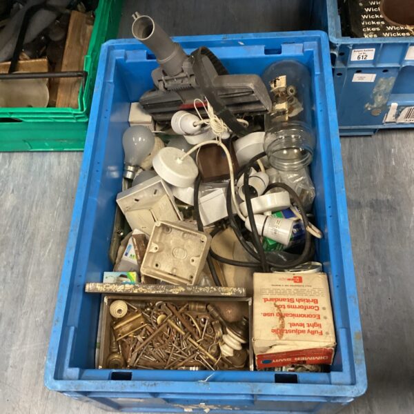 Blue crate filled with mixed ceiling light fittings, bulbs and electrical plugs.