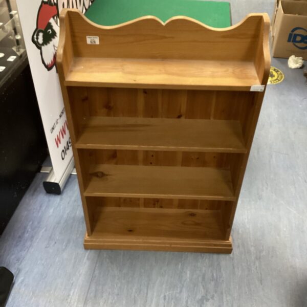Vintage solid pine bookcase with three shelves for storage.