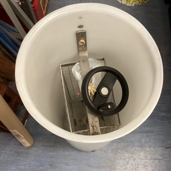 White honey extractor kit with stainless steel basket.