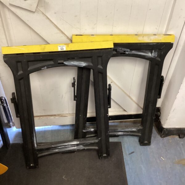 Pair of vintage metal folding saw horses for workshop use.