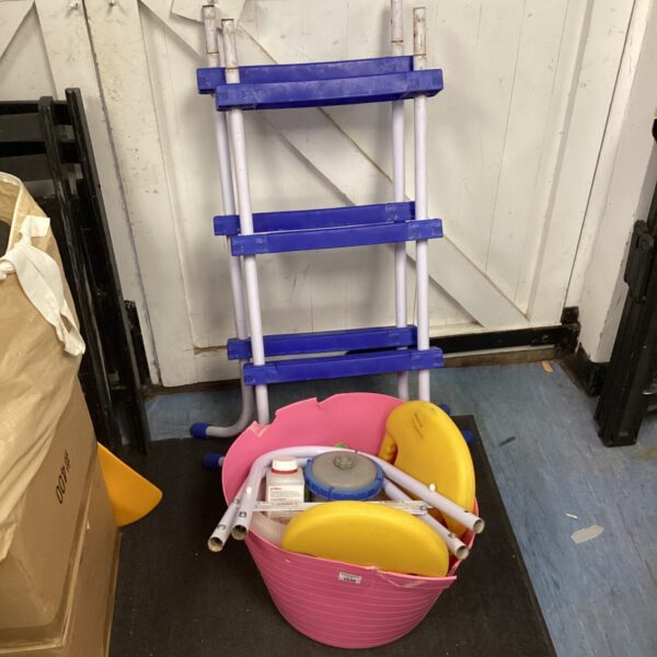 Pool ladder and accessories lot for swimming pool maintenance.