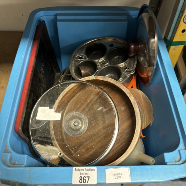 Assorted kitchen utensils including a metal pan in a box.