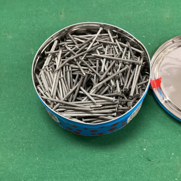 Tub of approximately 4-inch steel nails for construction projects.