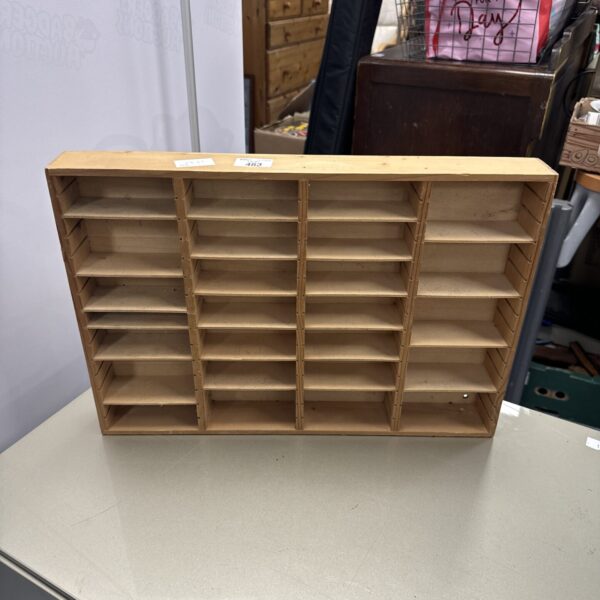 Vintage wooden model car display rack for collectors.