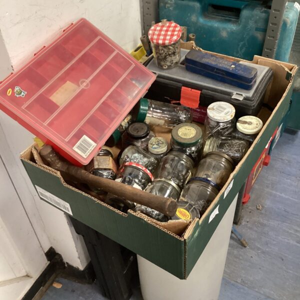 Mixed hardware lot with nails, screws, and a toolbox.