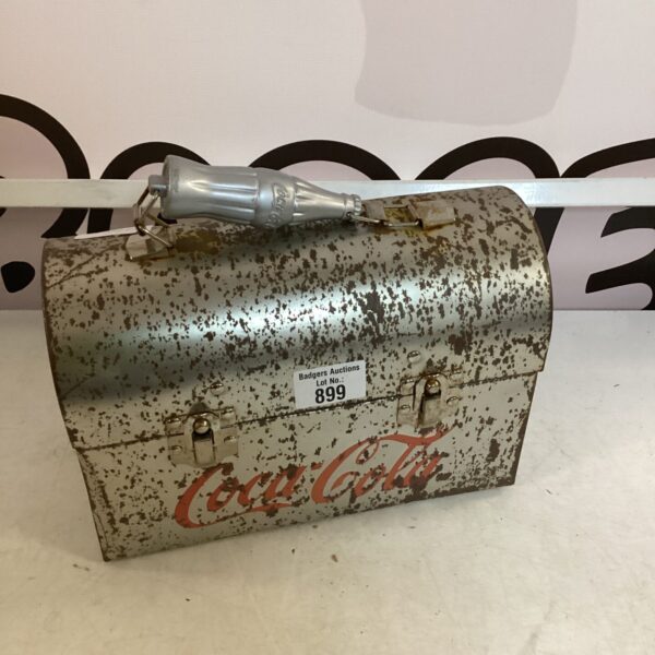 Vintage Coca Cola tin lunchbox with classic branding.