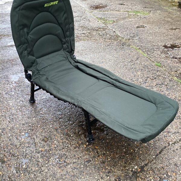 Padded folding fishing chair for comfortable angling sessions.