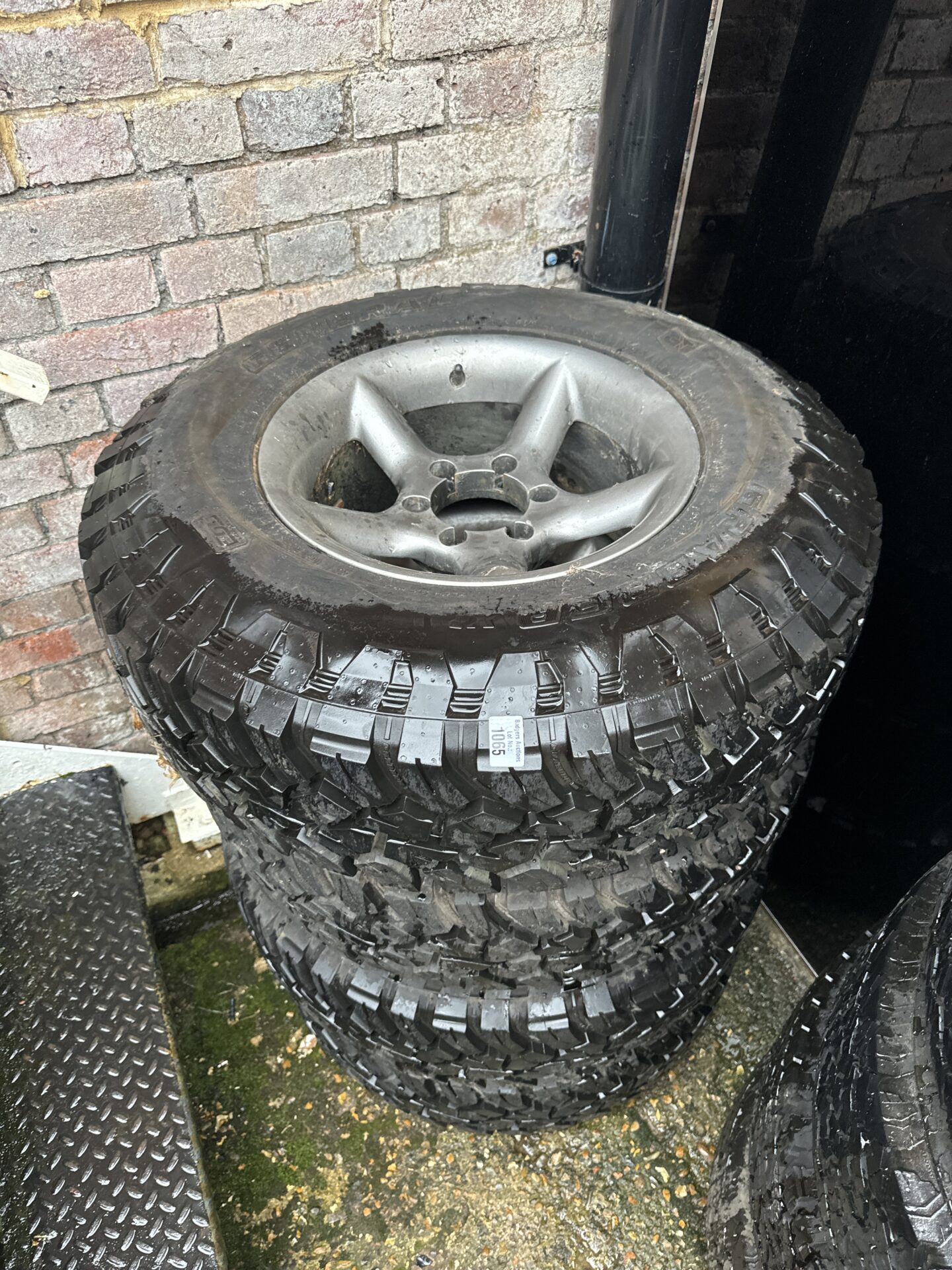 1065 Set of four Japanese pickup alloy wheels with grabber off road tyres (believed to be from an l200, tyres have lots of tread) 235 85 r16