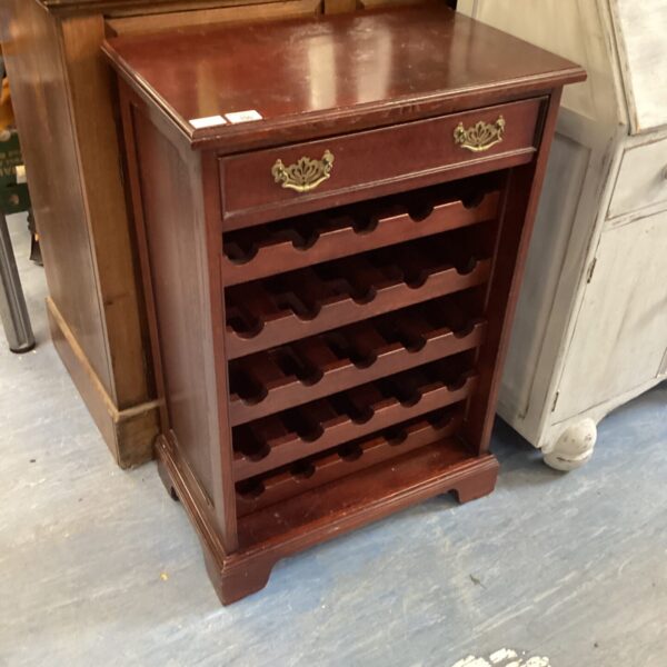 Dark wood wine cabinet with bottle storage and a drawer.