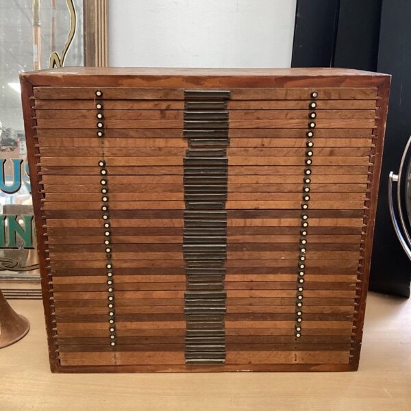 Vintage wooden collector drawers for stamps or coins.