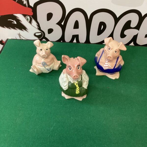 Group of three vintage NatWest piggy banks.