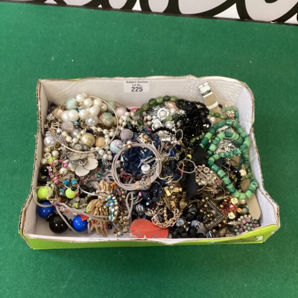 Assortment of vintage costume jewellery including necklaces and brooches.