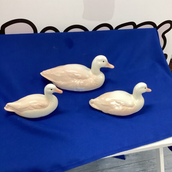 Vintage porcelain duck figurines in a collectible lot.